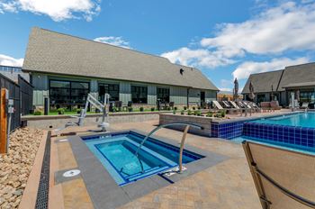 A swimming pool with a slide and a building in the background.